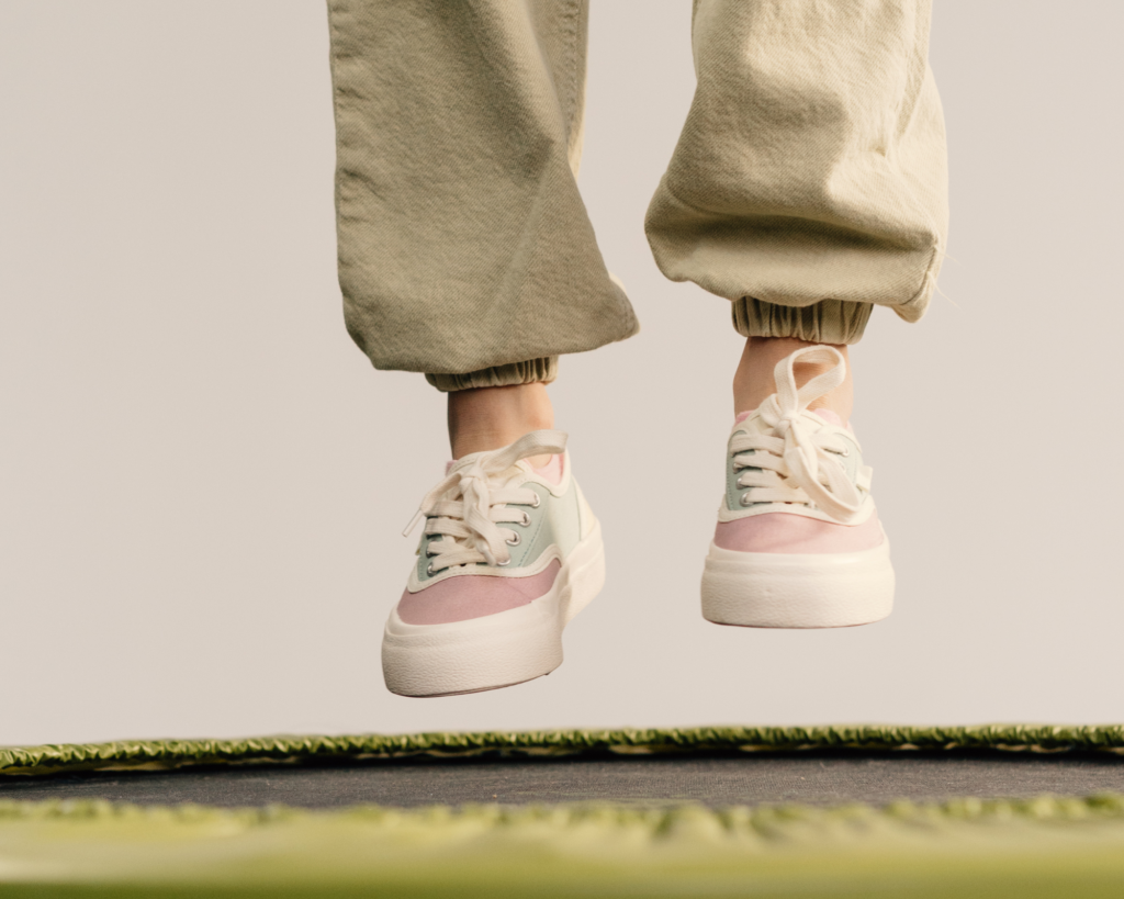 Photo of child's feet jumping off a trampoline.