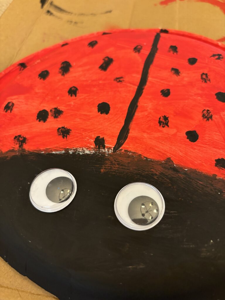 Close-up of paper plate ladybug craft