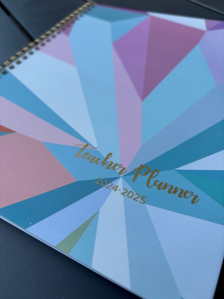 Photo of a spiral bound planner with pastel geometric shapes.